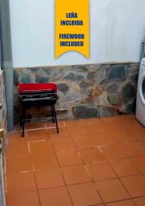 a piano in a room with a sign on the wall at Ruralux Aroche in Aroche