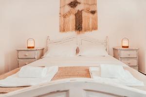 a bedroom with a white bed with two night stands at Altura Beach Villa by GT House in Altura