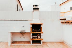 a kitchen with a counter and a sink at Altura Beach Villa by GT House in Altura