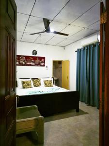 a bedroom with a bed and a ceiling fan at Sea Bay in Kamburugamuwa