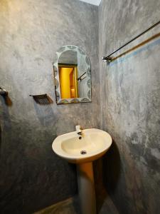 a bathroom with a sink and a mirror at Sea Bay in Kamburugamuwa