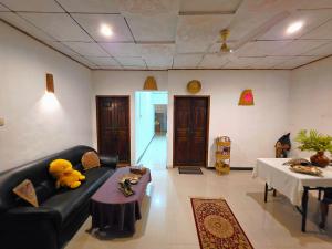 a living room with a teddy bear sitting on a couch at Sea Bay in Kamburugamuwa +10 photos