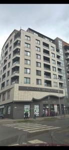 a large building with people walking in front of it at GALAXY apartment in Sofia +3 photos