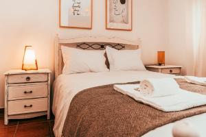 a bedroom with a bed with a blanket and a night stand at Altura Beach Villa by GT House in Altura