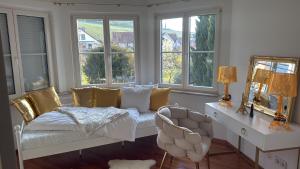 a living room with a couch and some windows at Villa Löwe - Heated Indoor Pool, Spa & Wellness Estate near Basel in Kandern +19 photos