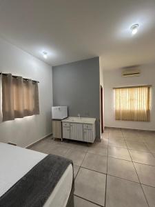 a bedroom with a bed and a window in it at Flat Monte Mor Jardim Monte Verde in Monte Mor