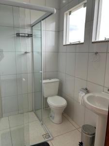 a bathroom with a toilet and a sink at Flat Monte Mor Jardim Monte Verde in Monte Mor