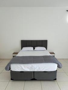 a bed with two pillows on it in a bedroom at Flat Monte Mor Jardim Monte Verde in Monte Mor