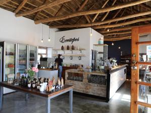 a man standing at the counter of a restaurant at The Old Posthouse in Ladismith