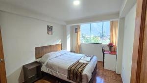 a hotel room with a bed and a window at Refugio Sagrado Boutique in Ollantaytambo