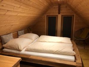 a bed in a wooden room in a cabin at Pension Patz in Schladming