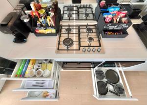 an open kitchen with a stove and some food at The Luxury Penthouse at Spring Square in Bankstown +20 photos