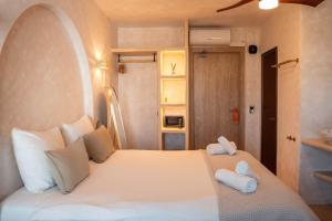a bedroom with a white bed with towels on it at Hotel Galfi - Boutique & Adults Only in San Antonio +42 photos