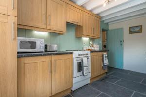 Kuchyň nebo kuchyňský kout v ubytování Dinas-Ddu