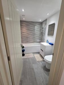 a bathroom with a toilet and a sink and a shower at City Centre 3BR WiFi & Parking For Contractors & Families in Hull