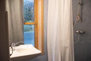 a bathroom with a sink and a window at Lødingen Brygge in Lødingen +71 photos