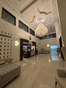 a large living room with a chandelier and a couch at The Silk Route Resort in Chanderi