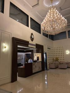 a large lobby with a chandelier in a building at The Silk Route Resort in Chanderi
