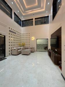 a large living room with a couch and a tv at The Silk Route Resort in Chanderi