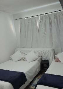 Postel nebo postele na pokoji v ubytování Quarto na praia banheiro compartilhado