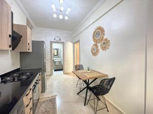 a kitchen with a table and a dining room at charming and cozy studio with swimming pool in Marrakesh