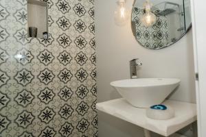 a bathroom with a sink and a mirror at Irini in Mesochórion