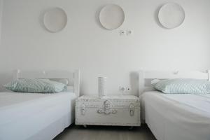 a bedroom with two beds and a nightstand between them at Irini in Mesochórion