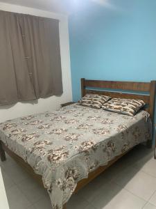 a bed in a bedroom with a blanket on it at Apartamento Itapoá in Itapoa