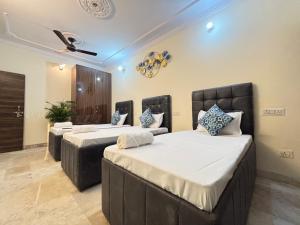 a room with two beds and a ceiling at Homestay Fortune Home Ansal Golf Link 1 in Greater Noida
