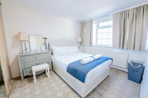 a small bedroom with a bed and a window at 3 BR House With Free Parking, Garden & Fast Wifi in Cardiff