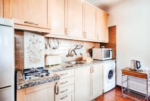 a kitchen with white cabinets and a washer and dryer at Amadora Terrace View By Gt House in Amadora
