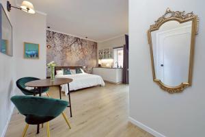 a bedroom with a bed and a table and a mirror at Dream Rome Aurelia apt pool&parking in Rome