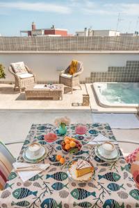 a table with plates of food on a patio at MandorleOlio in Polignano a Mare