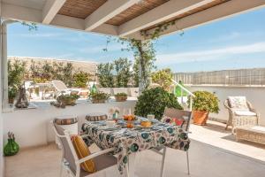 a patio with a table and chairs on a balcony at MandorleOlio in Polignano a Mare