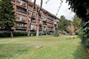 a large apartment building with a park in front of it at Dream Rome Aurelia apt pool&parking in Rome