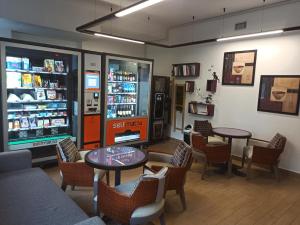 a restaurant with tables and chairs and a soda machine at Dream Rome Aurelia apt pool&parking in Rome
