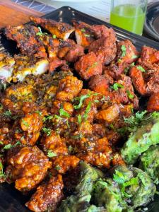 a tray of food with meat and broccoli at Mango Trails - Farm Stay, Camping & Day Outing near Bangalore in Talai