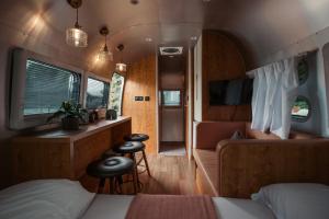 a bedroom with a bed and a couch and a table at A'moss Farmstay in Cameron Highlands