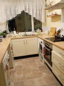 a kitchen with a stove and a dishwasher at Dana's room - free wifi & parking in Skellingthorpe