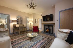 a living room with a couch and a fireplace at Church Cottage in Lochend