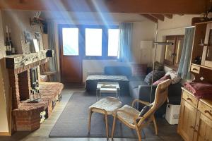 ein Wohnzimmer mit einer blauen Couch und einem Kamin in der Unterkunft Dachferienwohnung Vieux Valais A, Ost-Mitte in Riederalp