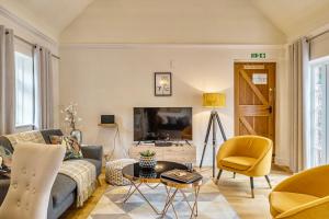 a living room with a couch and a tv at Whitmoor Farm in Guildford