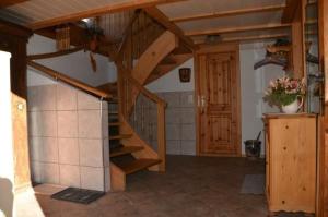 a room with a wooden staircase in a house at Breiten in Brunnadern
