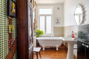 a bathroom with a tub and a sink at Jolie Maison en Bois Authentique in Dunkerque +38 photos