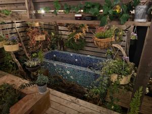 a garden tub filled with lots of plants at Yamanokami Inn in Nakatsugawa