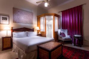 
a bedroom with a large bed and a large window at Fothergills of Fremantle in Fremantle
