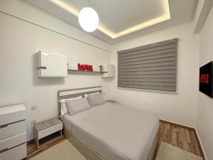 a bedroom with a white bed and a window at charming and cozy studio with swimming pool in Marrakesh