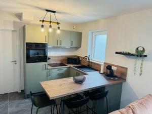 a kitchen with a wooden counter top in a room at Le cocon de pernelle in Couvin