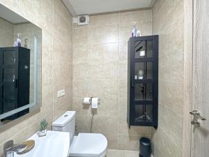 a bathroom with a toilet and a sink and a mirror at charming and cozy studio with swimming pool in Marrakesh +8 photos