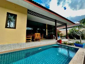 a house with a swimming pool in front of it at 3 bedroom villa with swimming pool Lamai in Nathon Bay +7 photos